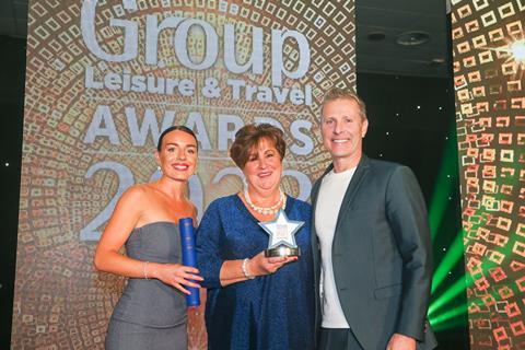 Ivana Perkins from Who's Who in Group Leisure presents the GLT award to Marie McCarthy of Irish Ferries, alongside host Paul Zerdin.